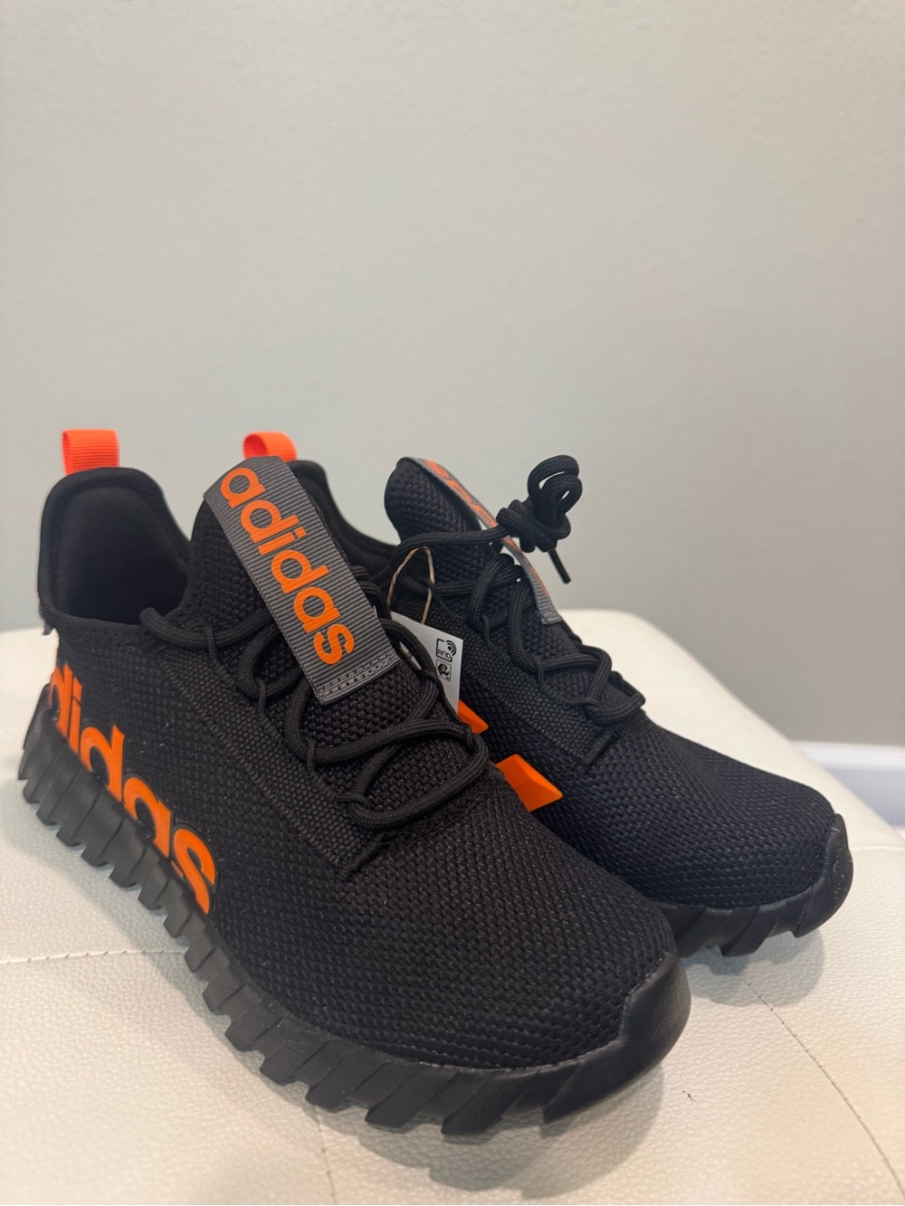 adidas Women’s Black Sneakers with Orange Logo Accents